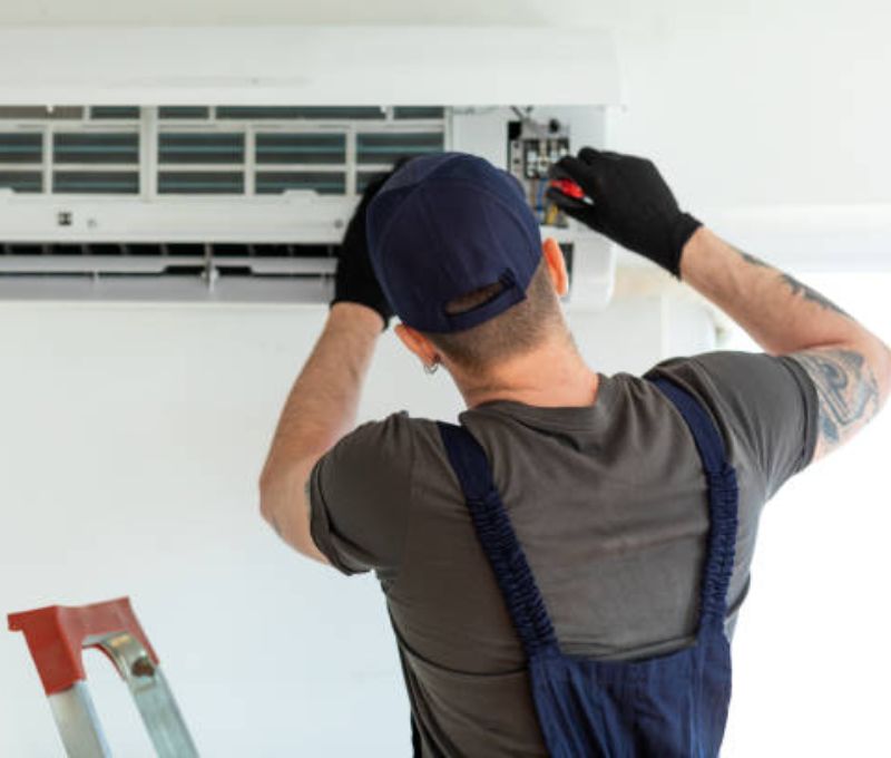 HVAC technician reviewing indoor air quality equipment